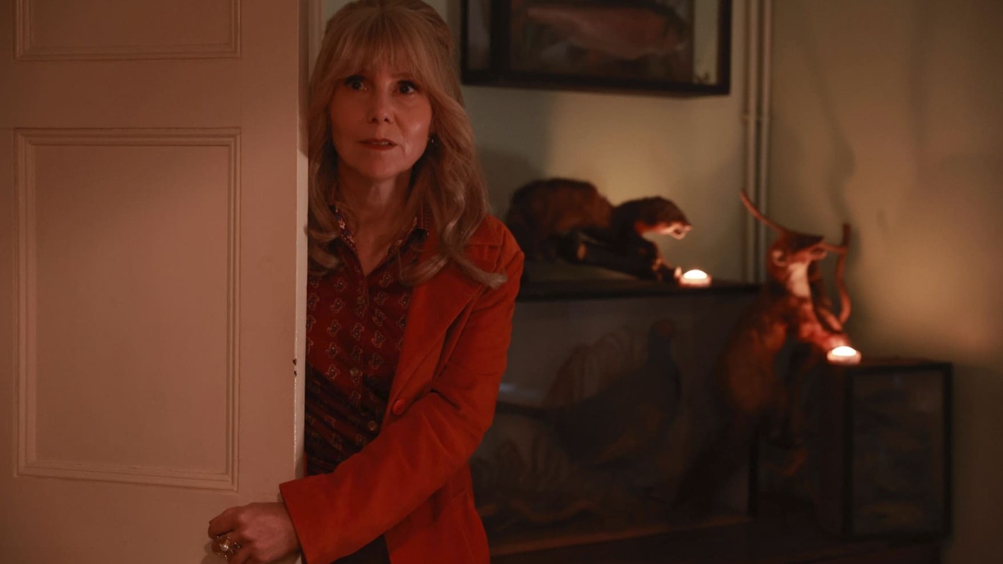 Actresses Sally Phillips peers around a doorframe in promotional image for The Hairdresser Mysteries
