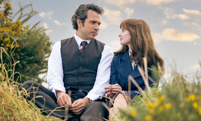 Tom Cullen and Lola Petticrew sat on grass staring lovingly at each other in the Channel 4 drama Trespasses