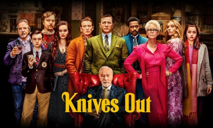 Poster for the film “Knives Out” showing a group of people in colourful, stylish outfits standing in front of an elegant interior, with the title in bold yellow letters
