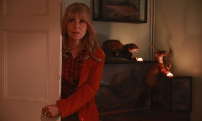 Actresses Sally Phillips peers around a doorframe in promotional image for The Hairdresser Mysteries