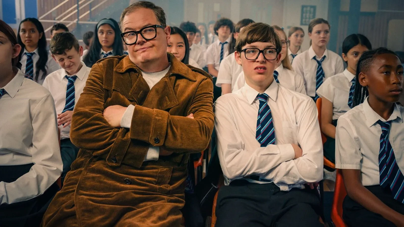 Alan Carr and Oliver Savell playing Alan Carr sat in school uniform in the comedy Changing Ends