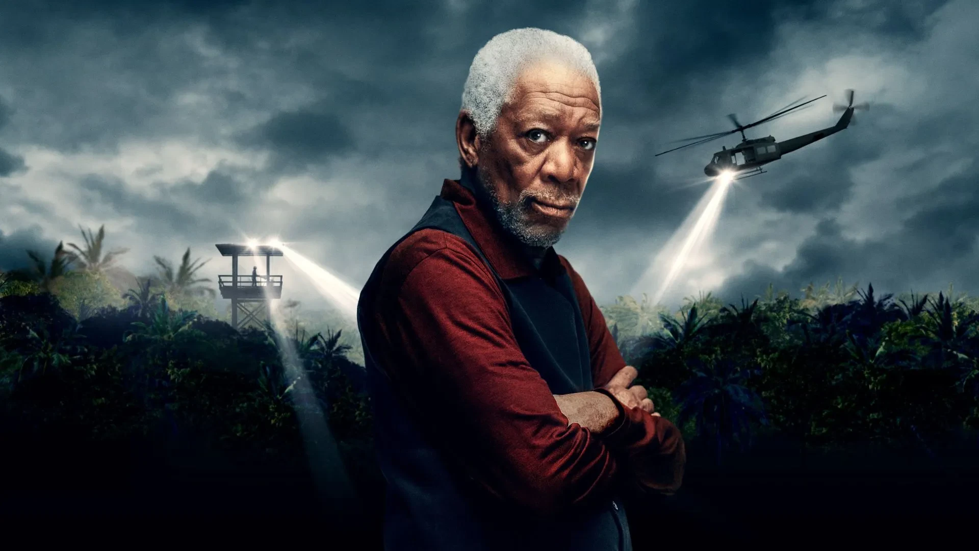 Morgan Freeman stood against a cloudy backdrop with helicopters searching for something 