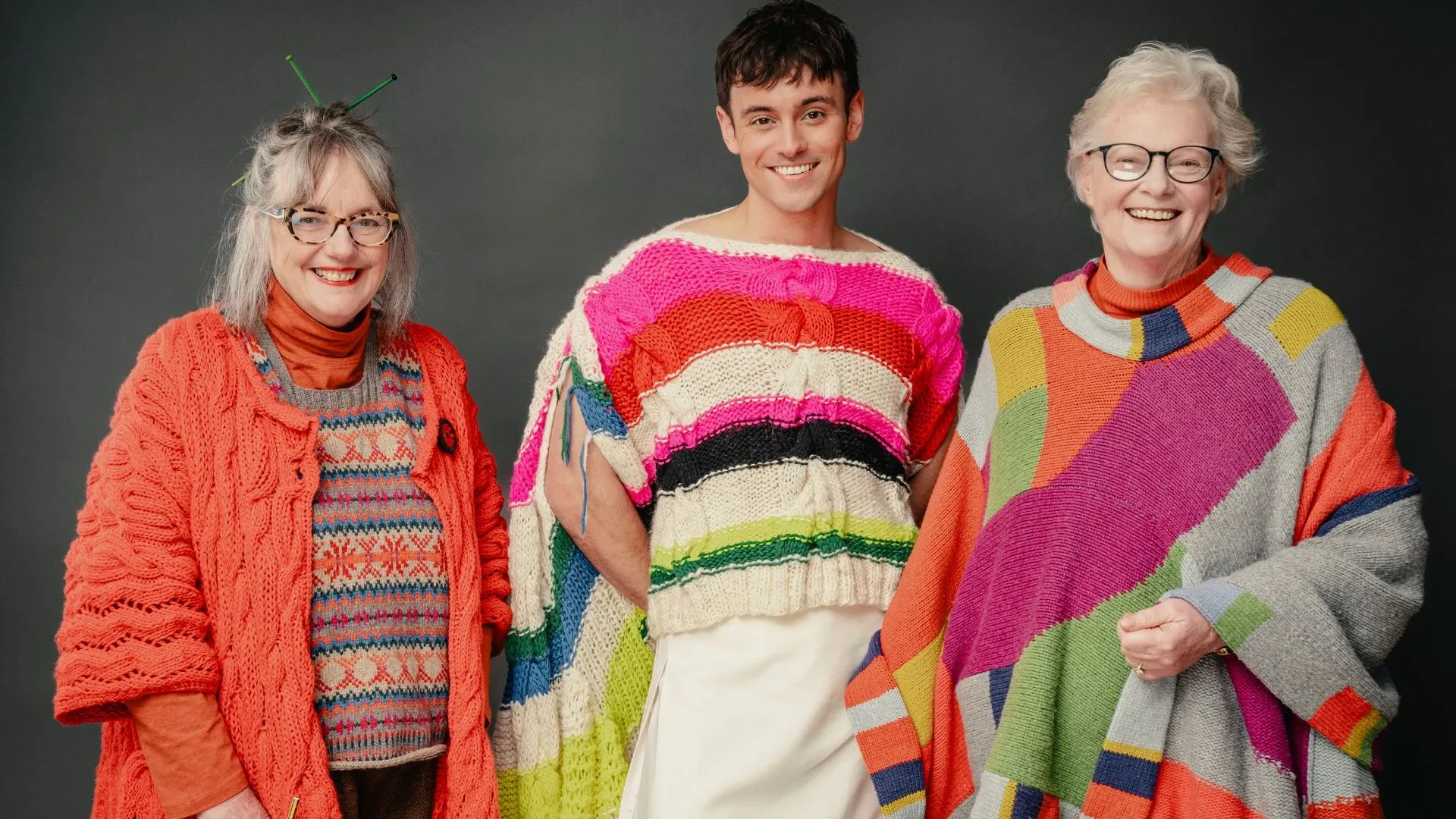 Tom Daley, Di Galpin and Sheila Greenwell wearing woollen jumpers in the show A Game of Wool