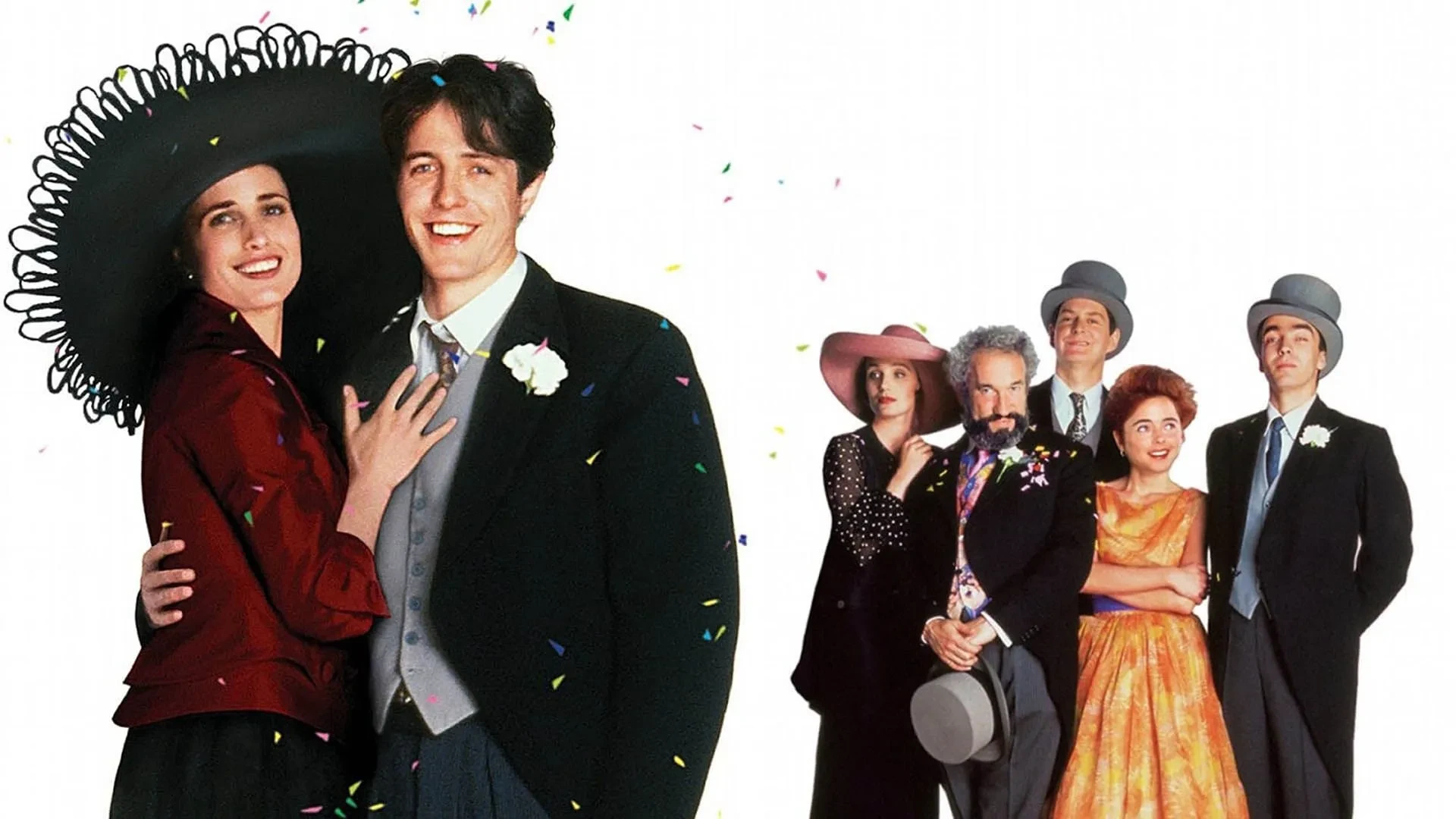 Promotional image from the film Four Weddings and a Funeral, featuring a group of people dressed in formal wedding attire. Two individuals stand in the foreground, with one wearing a large black hat and a dark red jacket, and the other in a black suit with a white boutonnière. In the background, four more people are dressed in elegant outfits, including colourful dresses and grey top hats, with confetti scattered across the scene.