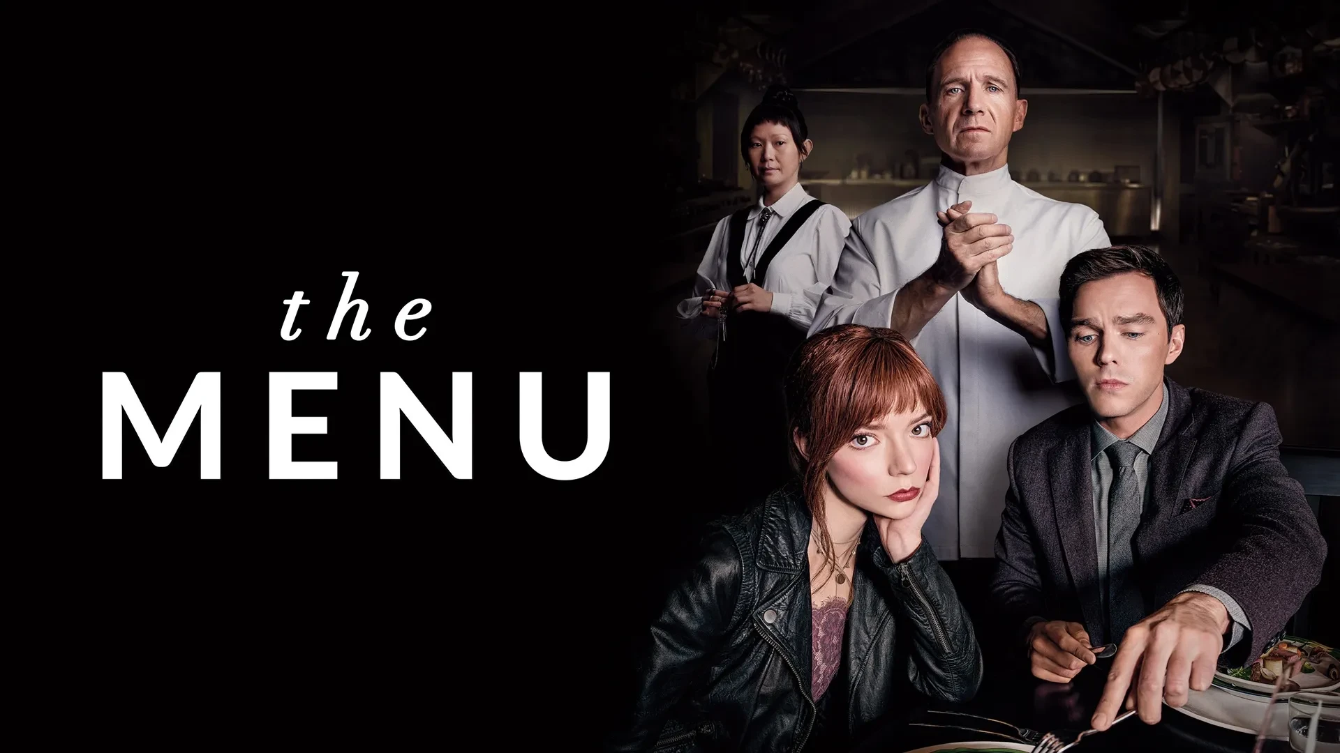 Promotional image for the 2022 film The Menu, showing a fine dining setting with two people seated at a table with gourmet dishes and wine, and two chefs standing in a dimly lit kitchen background. 