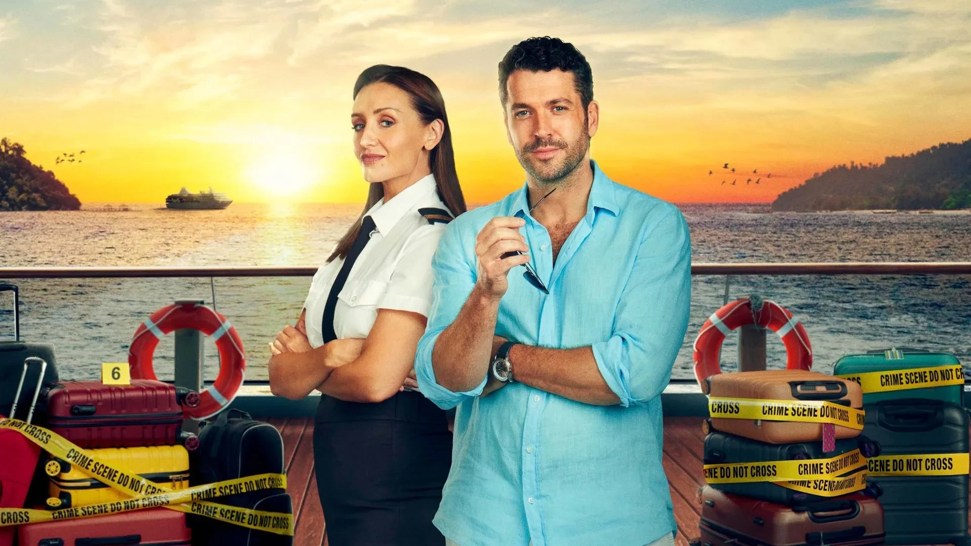 Poster image for the third season of the British crime drama The Good Ship Murder, showing two people standing on a ship deck at sunset. One is wearing a light blue shirt and holding a pen, while the other is in a white shirt with black epaulettes. Around them are suitcases wrapped in yellow crime scene tape, with the sea and distant islands in the background. 