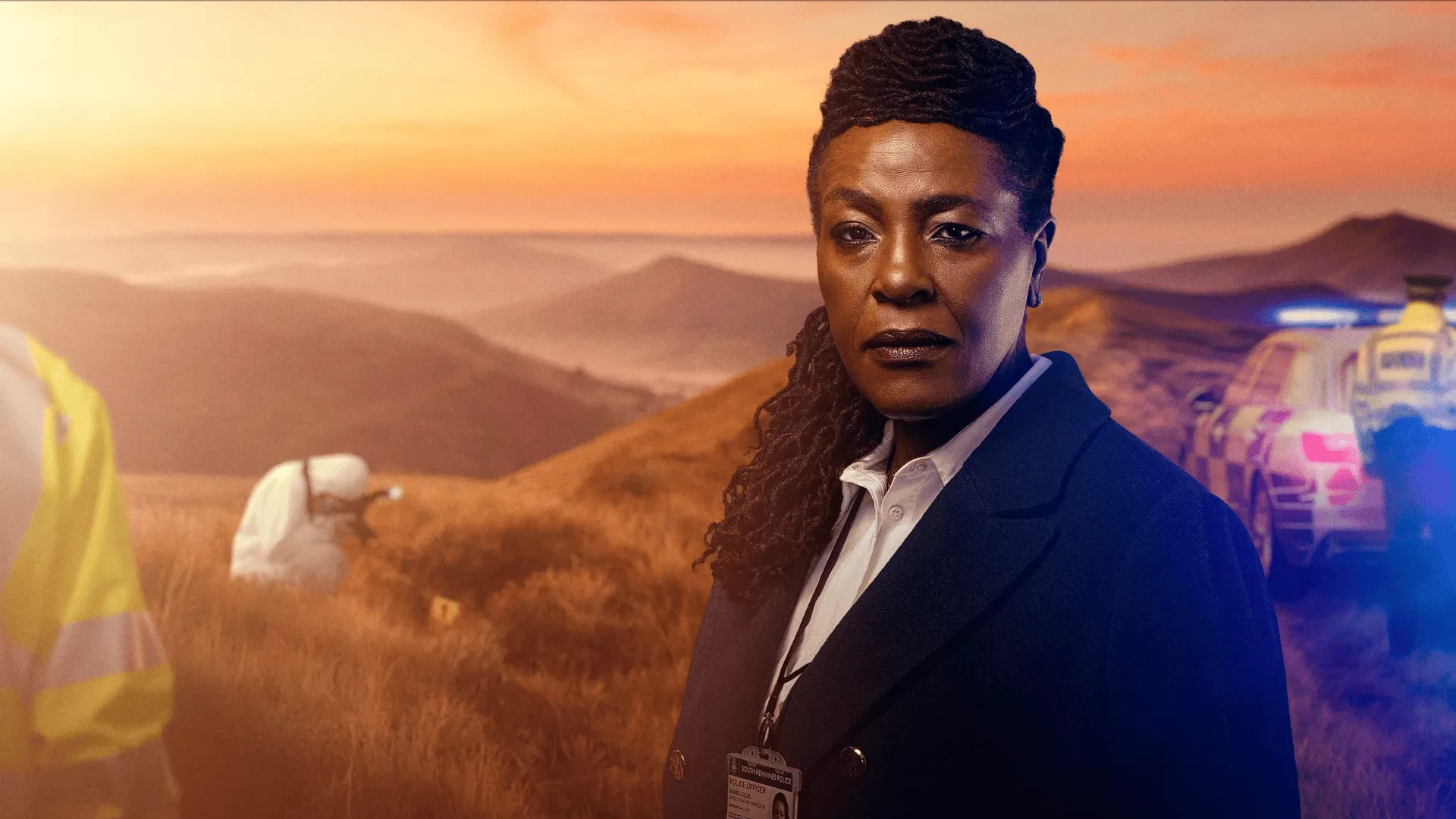 Investigator standing on a hillside at sunset with police vehicles and a forensic team working in the background.