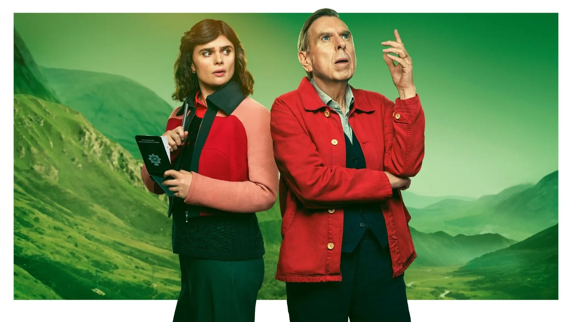Promotional image for the drama series Death Valley, showing two people standing back to back in a mountainous landscape, one holding a notebook, both wearing red‑toned jackets against a green valley backdrop.