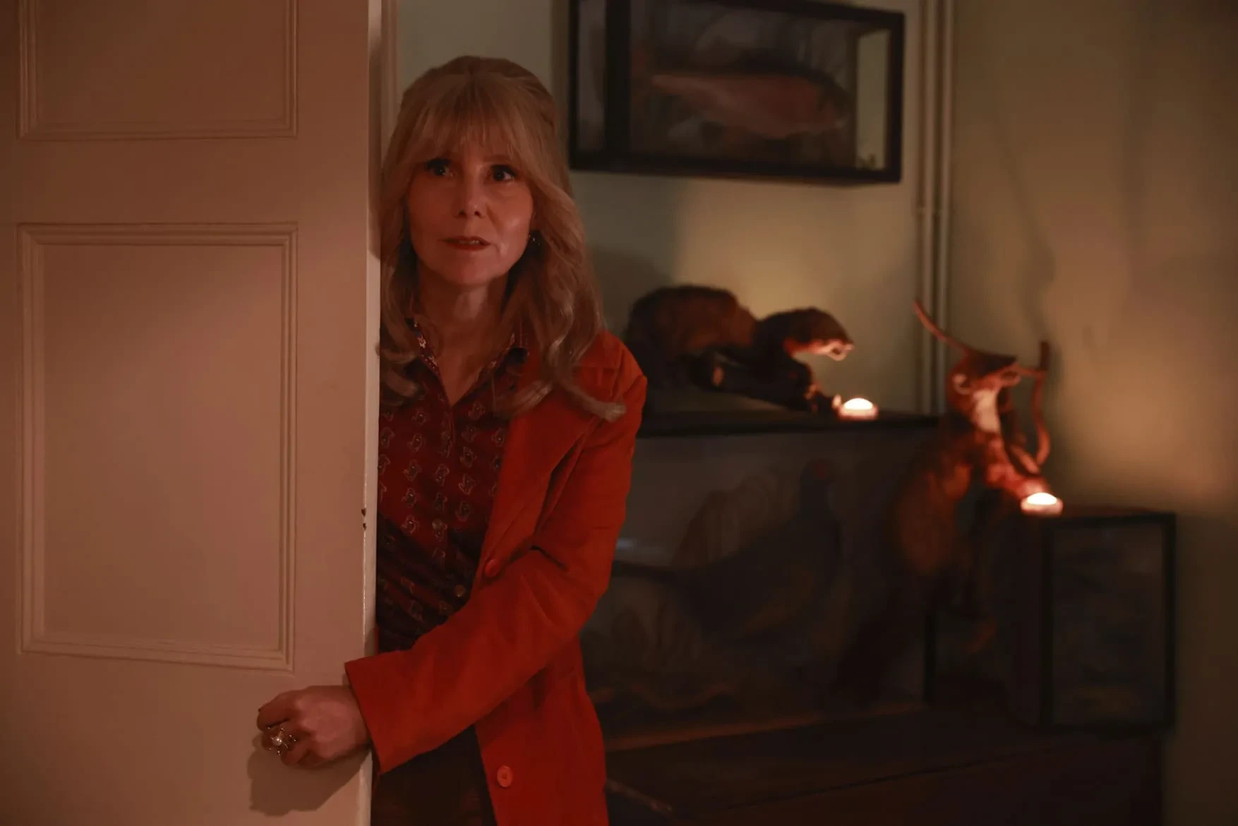 Actresses Sally Phillips peers around a doorframe in promotional image for The Hairdresser Mysteries