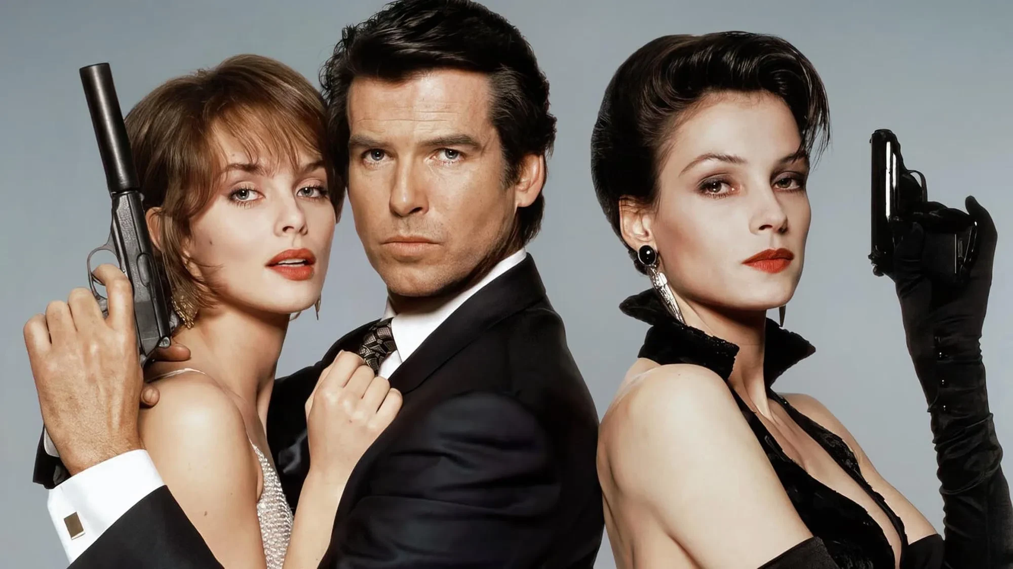 Promotional image for GoldenEye (1995) featuring Izabella Scorupco, Pierce Brosnan, and Famke Janssen