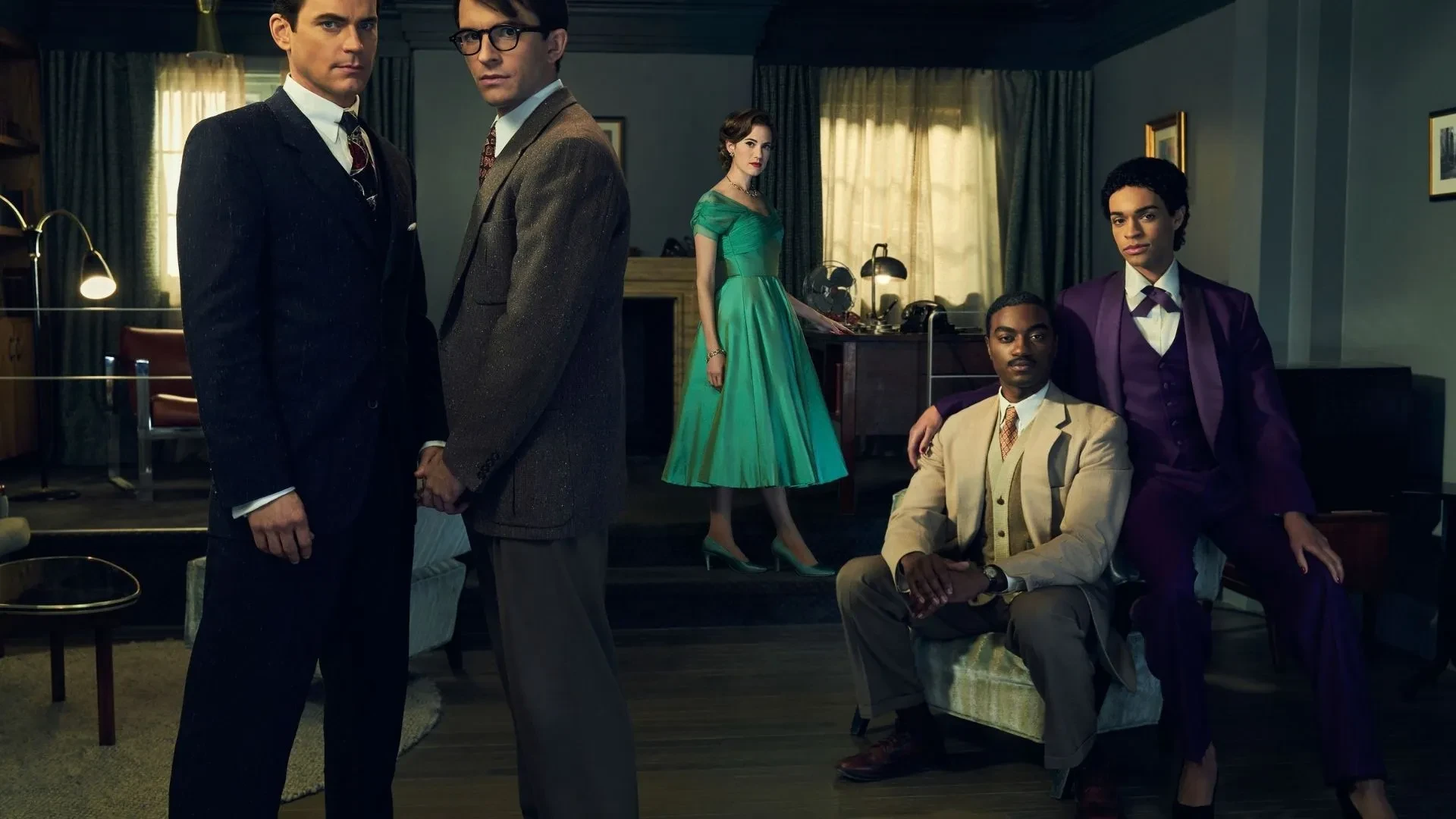 Key art for the drama Fellow Travellers. Two young men holding hands in 20th century suits, a young male couple behind them in suits from a different era and a women in a green dress sat at a 1940s desk.